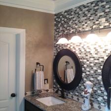 Shimmering Lusterstone walls and faux salvaged walnut glazed vanity with blue ceiling